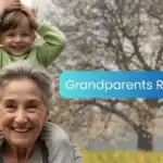 Smiling grandmother carrying a young child on her shoulders outdoors with the words "Grandparents Rights," representing grandparent rights, family bonding, and intergenerational connection