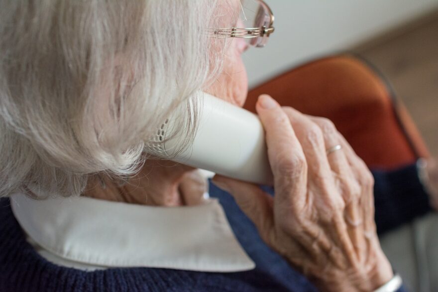 Older grandmother talking on a phone, showing communication, caregiving, and the realities of grandparenting