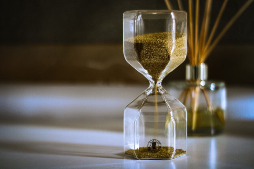 Hourglass with golden sand, a simple symbol for time, patience, and meaningful moments in grandparenting.