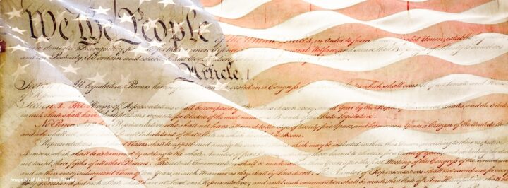 Vintage United States Declaration of Independence displayed over an American flag, representing American history and family lessons shared across generations.