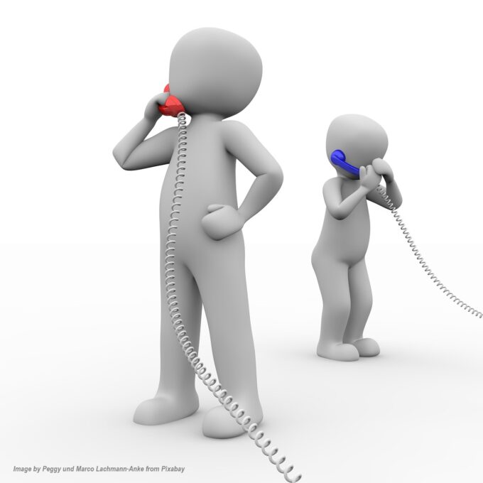 Adult and child talking on corded phones to symbolize communication between generations