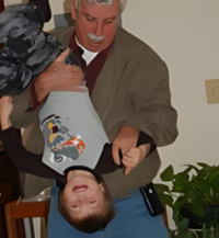 Neil Taft's signature upsidedown hug, this is his one way of creating lasting and meaningful connections to his grandlchildren