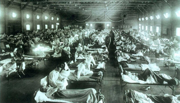Historic black and white photo of a crowded medical ward with rows of hospital beds and patients, illustrating caregiving, health, and family support themes relevant to grandparenting content.