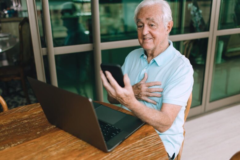 A grandparent using modern technology to communicate with grandchildren to stay connected with them.