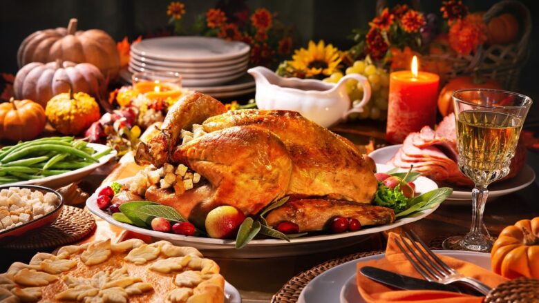 Thanksgiving dinner table with roast turkey, pies, and fall decorations, highlighting family gatherings, intergenerational celebration, and grandparenting traditions.