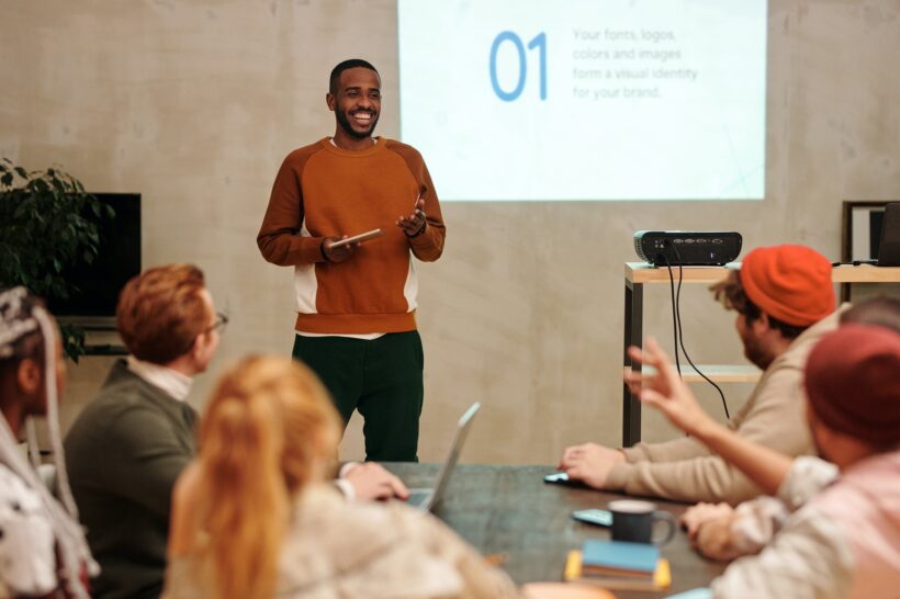 Presenter speaking to a group in a workshop setting, illustrating grandparenting education, family communication, and intergenerational learning
