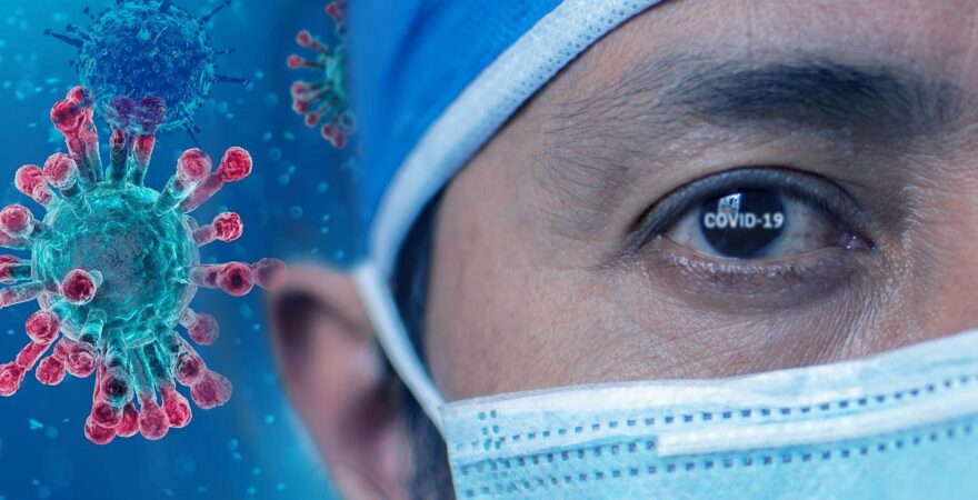 Healthcare worker wearing a mask near a coronavirus image, representing grandparenting health safety, COVID-19 protection, and family caregiving awareness