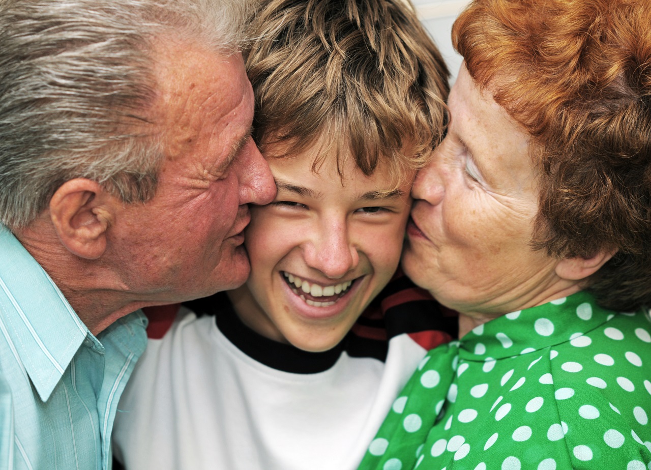 A portrain of grandparents kissing their grandson creating a beautiful and lasting moment