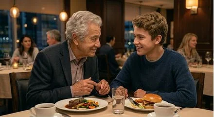 A grandfather eating with his grandson in a restaurant and having a meaningful conversation.